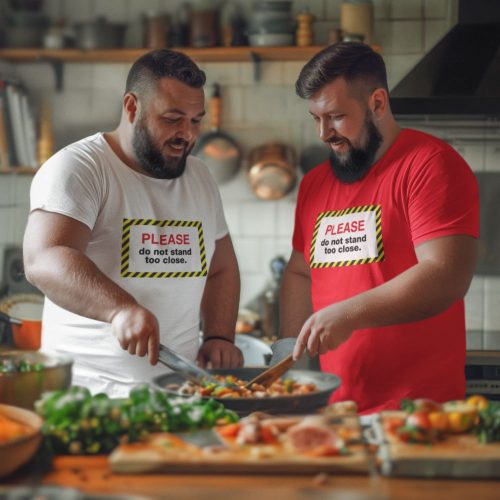 please-do-not-stand-too-close-mockup-of-two-men-wearing-t-shirts-at-a-cooking-party-inside-a-kitchen.jpg